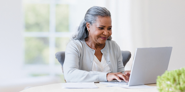 Man and woman looking at computer together smiling