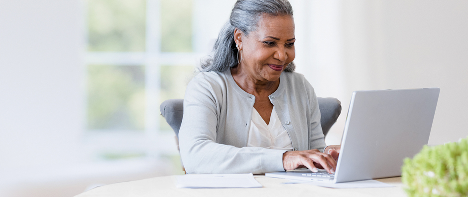 Man and woman looking at computer together smiling