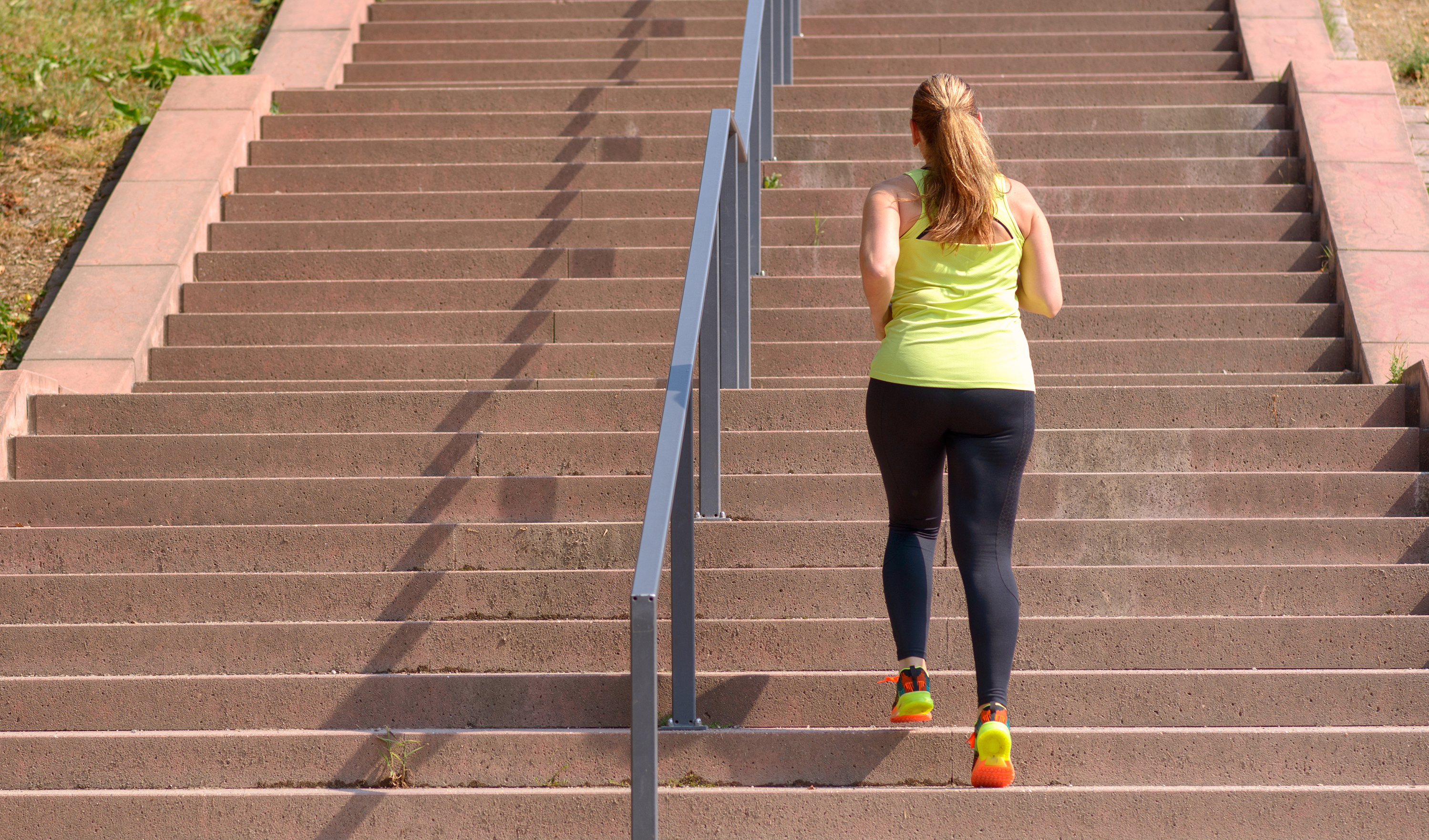 Women running up stairs outside